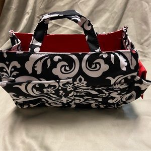 New with tag black, red, & white bag with pockets